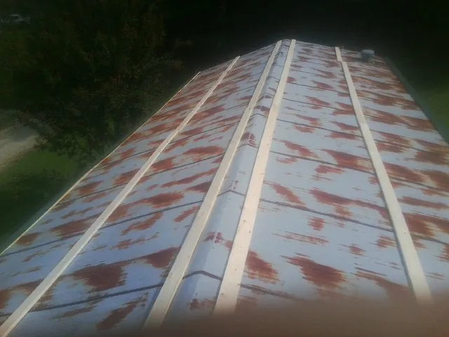 Rusted metal roof panels with new wood purlins before replacement — Storm Damage Roof Repair in Rhoadesville by Roofing Brothers